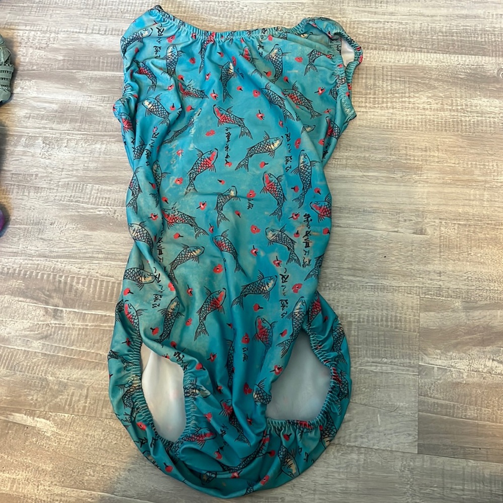Open back foxy leo with stretchy and Silkey material and has a design of fish